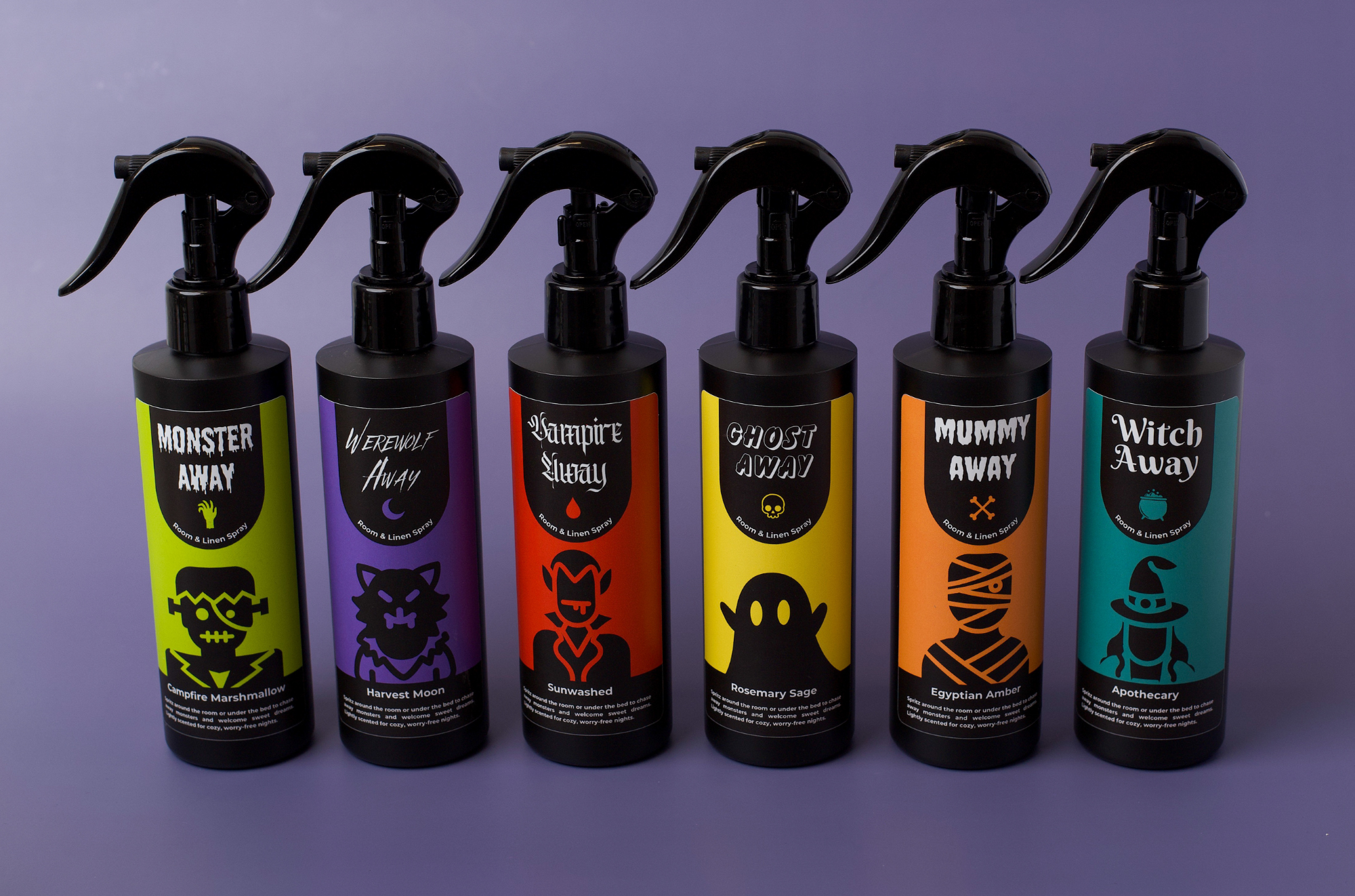 Six white spray bottles in a row showing different versions of monster spray.